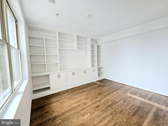 unfurnished living room featuring dark hardwood / wood-style floors