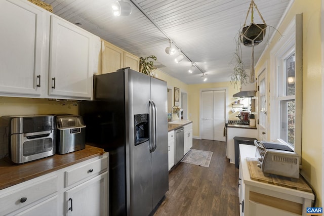 kitchen with wooden counters, stainless steel appliances, pendant lighting, white cabinets, and dark hardwood / wood-style floors