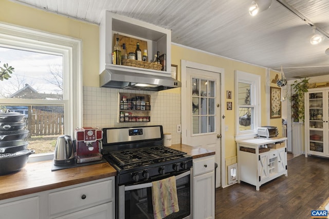 kitchen with wood counters, stainless steel range with gas cooktop, a wealth of natural light, and wall chimney exhaust hood