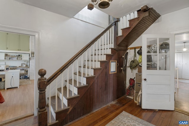 staircase with wood-type flooring