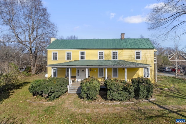 view of front of house featuring covered porch and a front lawn