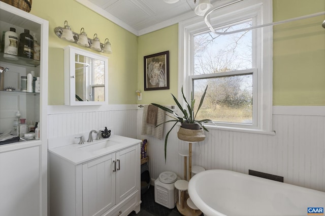 bathroom with a bathing tub, wood walls, and vanity