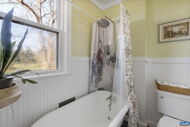 bathroom with toilet and shower / tub combo with curtain