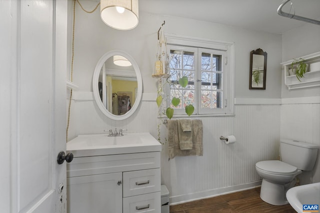 bathroom featuring wood-type flooring, vanity, and toilet