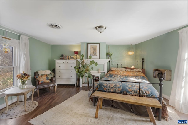 bedroom with dark hardwood / wood-style floors