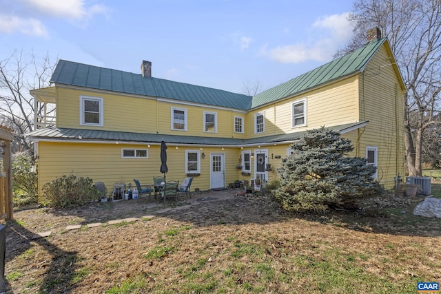 rear view of house with central AC unit