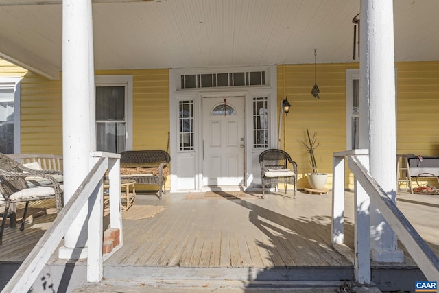 view of exterior entry with a porch