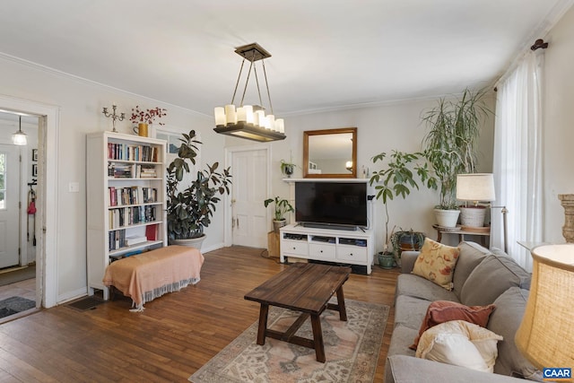 living room featuring crown molding and dark wood-type flooring