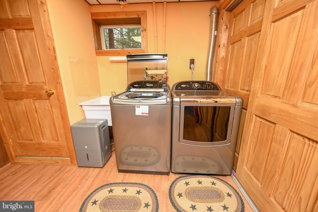 washroom featuring washer and dryer and light wood-type flooring