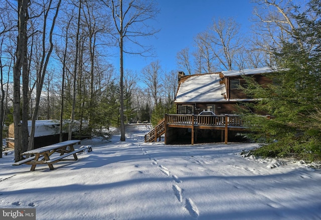 snowy yard with a wooden deck