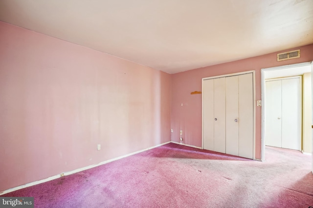 unfurnished bedroom featuring carpet and a closet