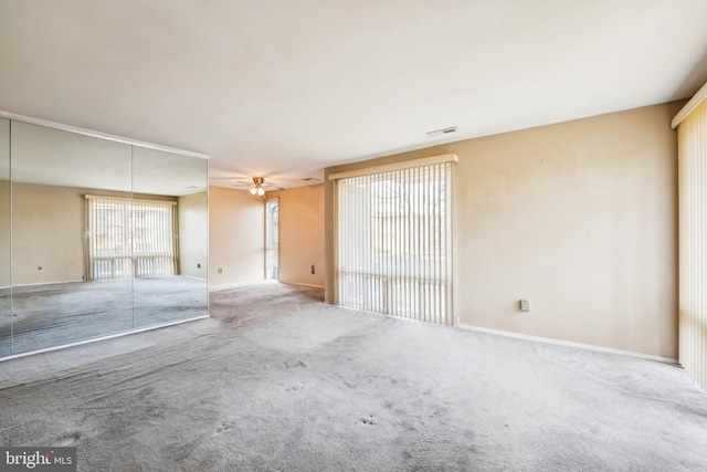 spare room with carpet flooring and ceiling fan