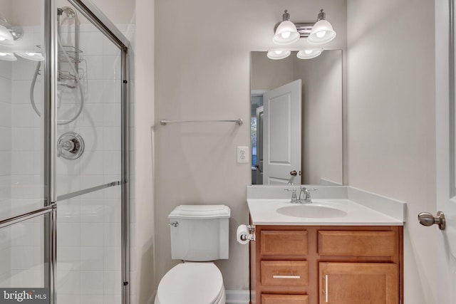 bathroom with vanity, toilet, and walk in shower