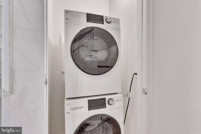 laundry room featuring stacked washing maching and dryer