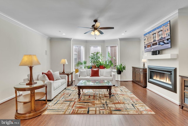 living room with crown molding, hardwood / wood-style floors, and ceiling fan