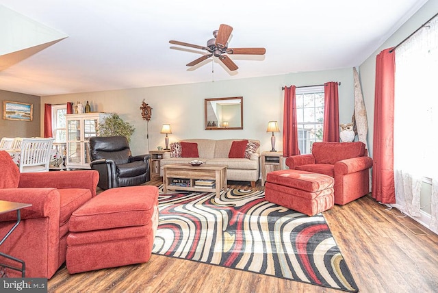 living room with ceiling fan and light hardwood / wood-style flooring