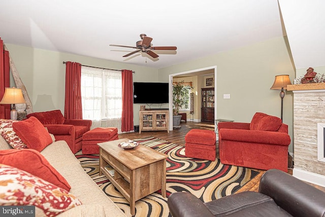 living room featuring hardwood / wood-style floors and ceiling fan