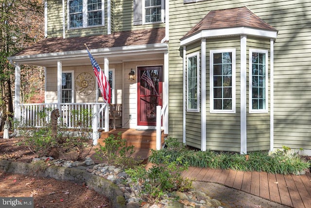 view of exterior entry with covered porch