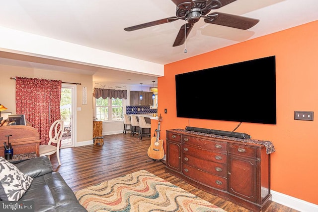 living room featuring dark hardwood / wood-style floors and ceiling fan