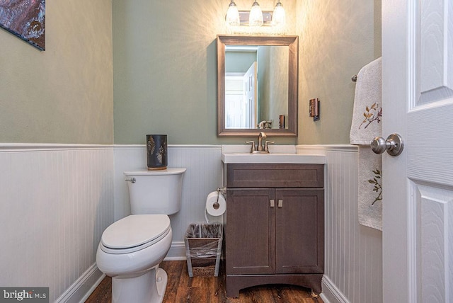 bathroom with vanity, toilet, and wood-type flooring