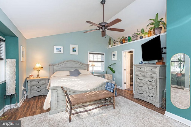 bedroom featuring high vaulted ceiling, ceiling fan, dark hardwood / wood-style flooring, and connected bathroom