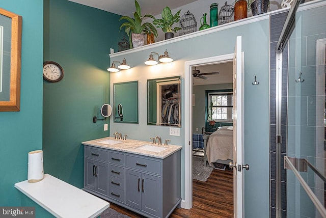 bathroom with hardwood / wood-style floors, vanity, and ceiling fan