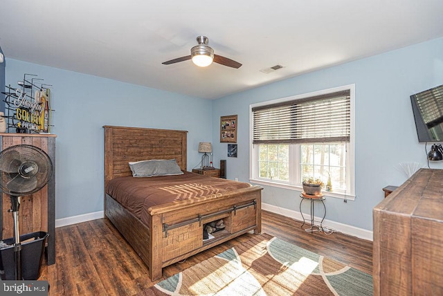 bedroom with ceiling fan and dark hardwood / wood-style floors