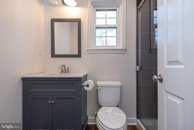 bathroom featuring vanity, toilet, and an enclosed shower