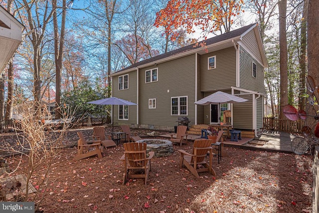 rear view of house with a fire pit