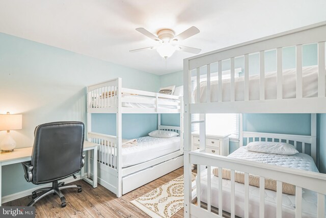 bedroom with wood-type flooring and ceiling fan