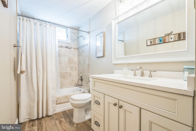 full bathroom with vanity, hardwood / wood-style floors, shower / bathtub combination with curtain, and toilet