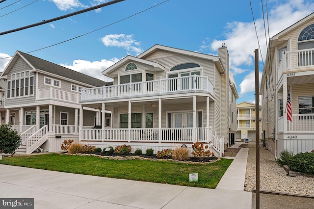 view of front of property featuring a porch and a balcony