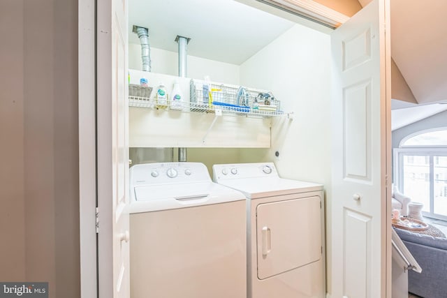 clothes washing area featuring washer and clothes dryer