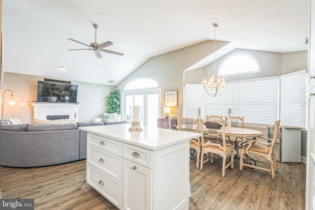 kitchen with white cabinets, plenty of natural light, pendant lighting, and light hardwood / wood-style flooring