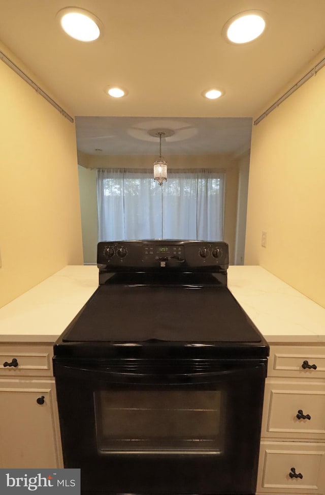 kitchen featuring white cabinets, decorative light fixtures, black range with electric stovetop, and kitchen peninsula