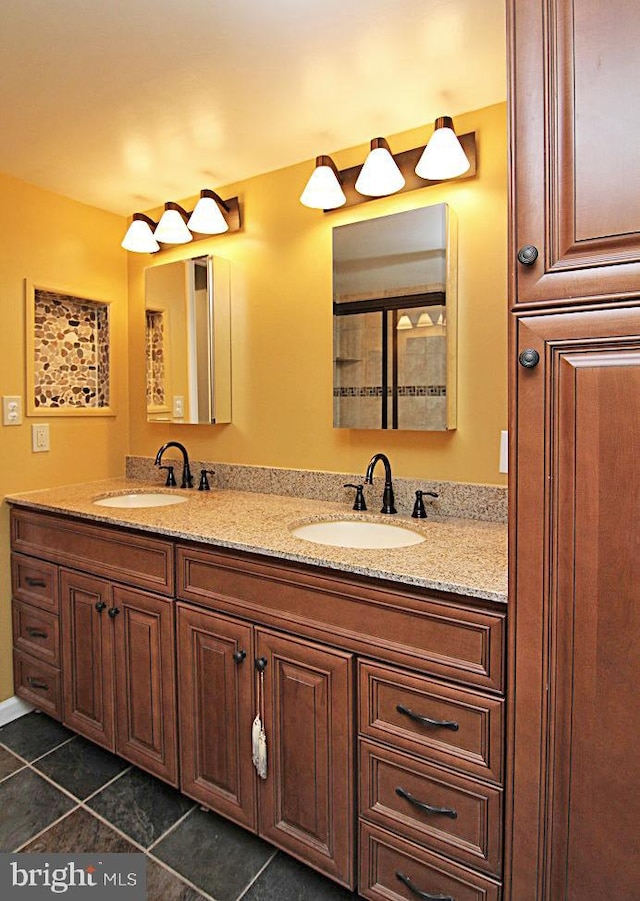 bathroom with tile patterned floors and vanity