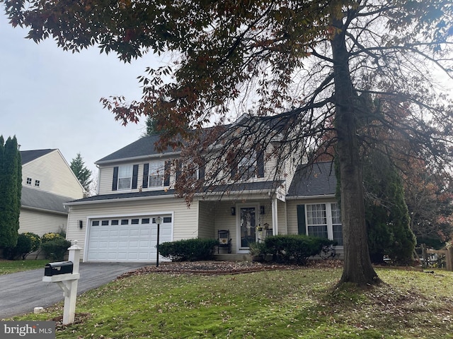 front facade featuring a garage and a front lawn