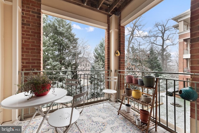 view of snow covered back of property