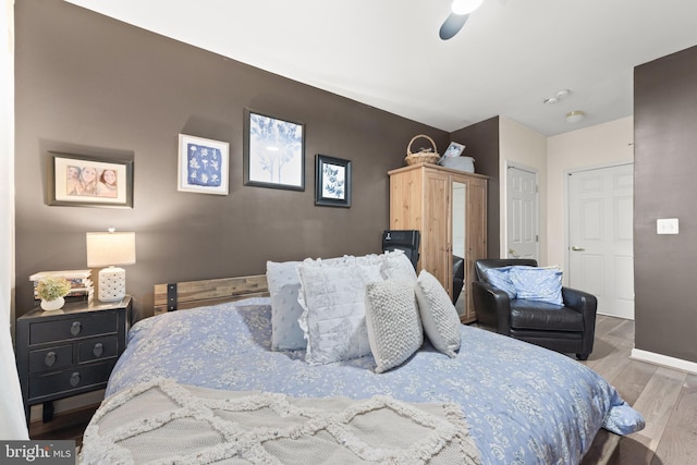 bedroom with ceiling fan and hardwood / wood-style floors