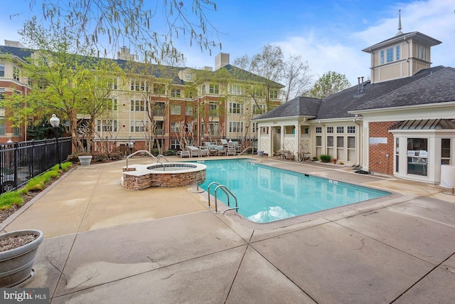 view of swimming pool with a hot tub and a patio area