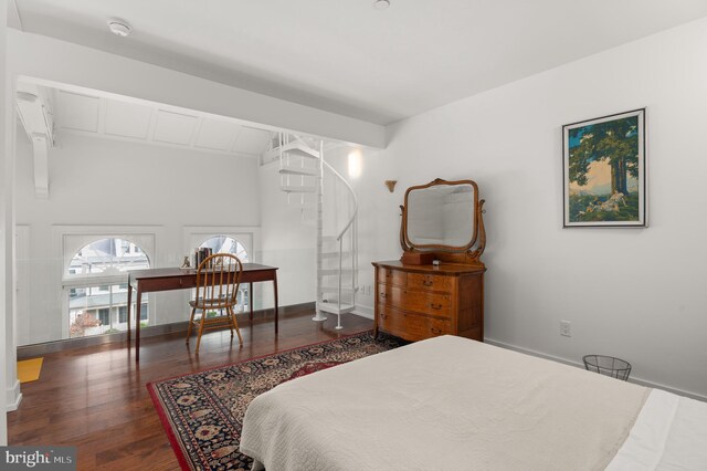 bedroom with beam ceiling and dark wood-type flooring