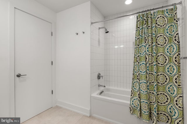 bathroom with tile patterned flooring and shower / bath combo with shower curtain