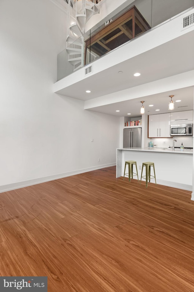 unfurnished living room with hardwood / wood-style flooring