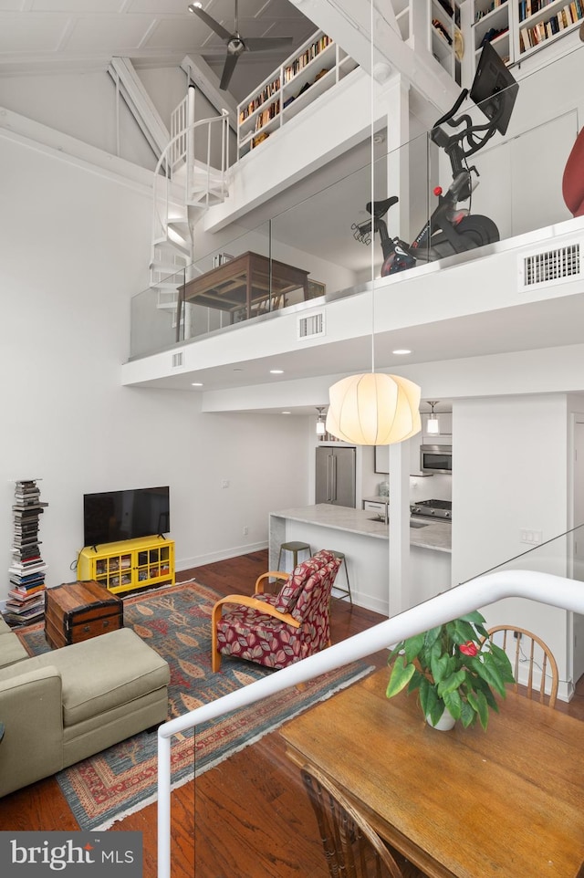 living room with hardwood / wood-style flooring and high vaulted ceiling