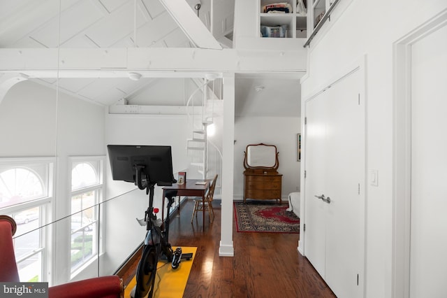 hallway featuring beamed ceiling, dark wood-type flooring, and high vaulted ceiling