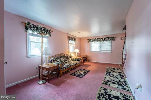 living room featuring carpet and plenty of natural light