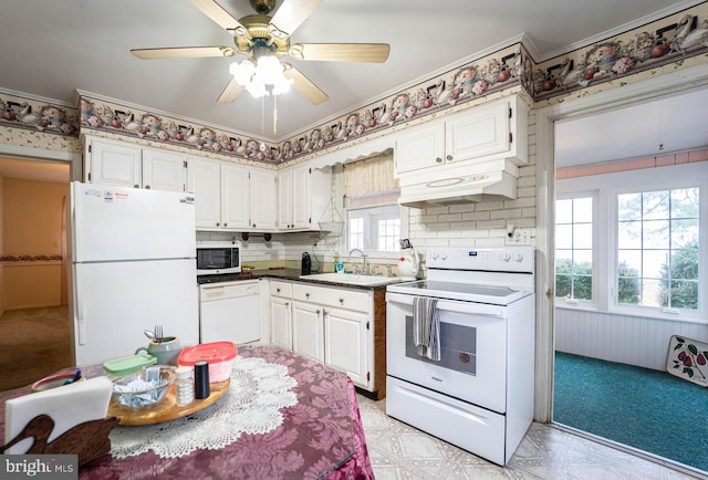 kitchen featuring decorative backsplash, white appliances, crown molding, sink, and white cabinets