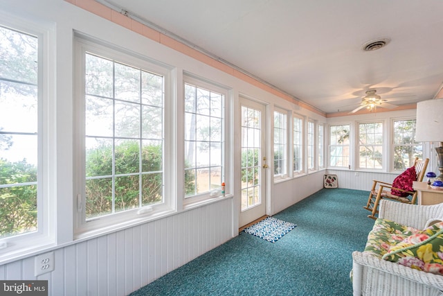 sunroom / solarium with a wealth of natural light and ceiling fan