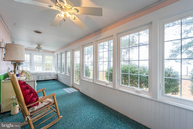 sunroom / solarium featuring a wealth of natural light and ceiling fan