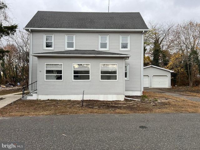 view of front of house with a garage and an outdoor structure